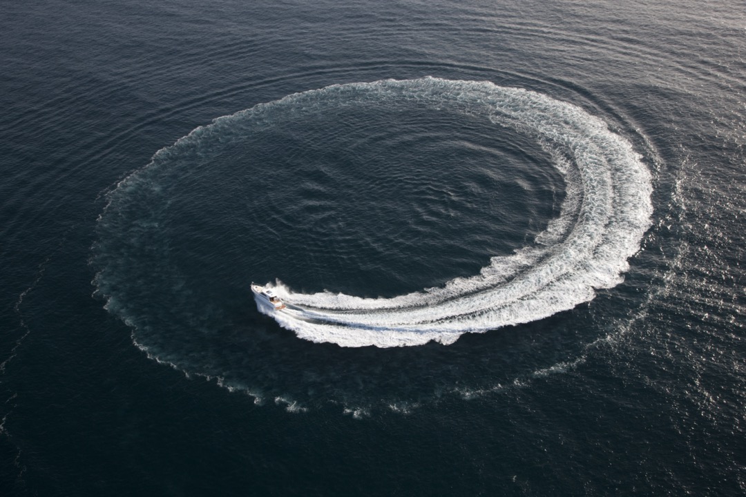 Small boat making a circle in the water.